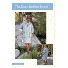 Cozy quilted dress worn by a model in a natural setting with text 'The Cozy Quilted Dress'.