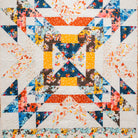 Colorful quilt with geometric pattern on a wooden wall background
