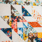 Colorful quilt with floral patterns and geometric shapes
