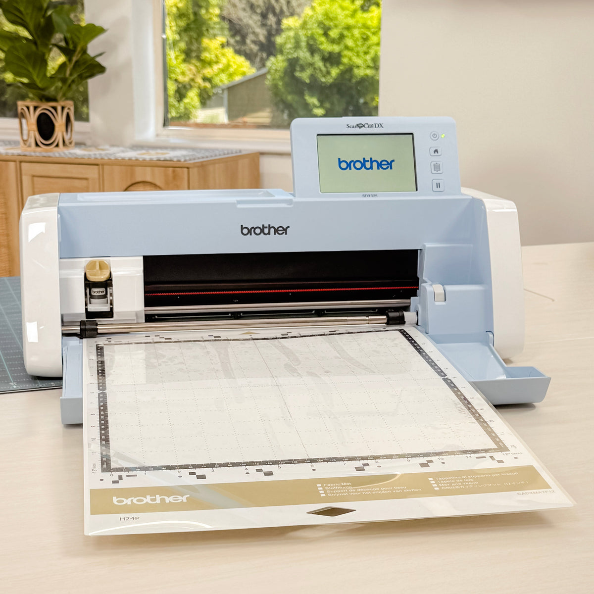 Brother machine on a table with a window view of greenery