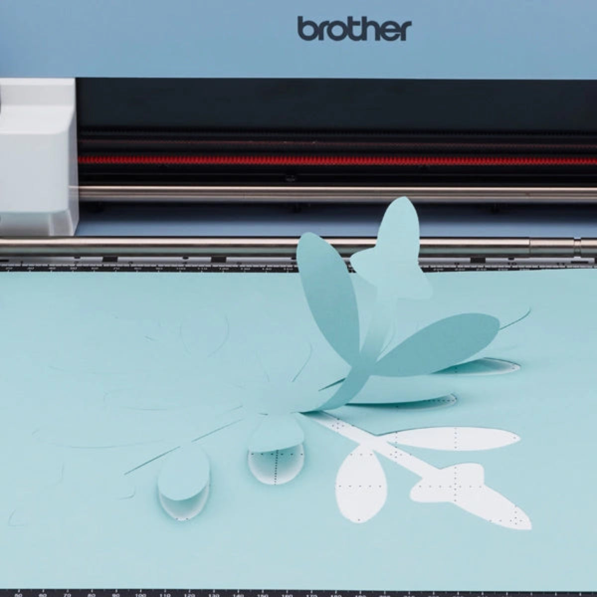 Brother cutting machine with paper cutout design on a white background