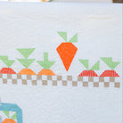 Quilt with carrot and rabbit pattern on a white background