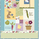 Patchwork quilt with garden-themed blocks featuring animals and plants.