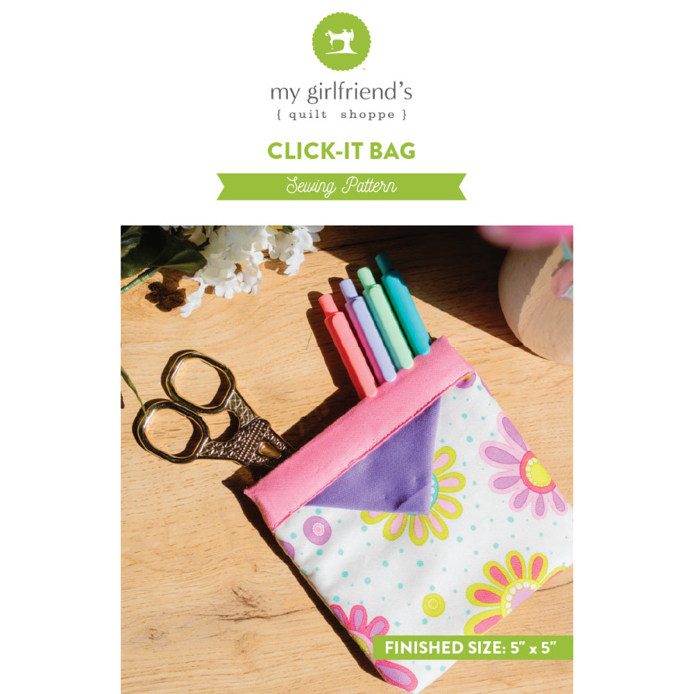 Floral-patterned sewing click-it bag with sewing tools on a wooden surface, featuring 'my girlfriend's quilt shoppe' branding.