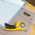 Rotary cutter on a cutting mat with grid lines