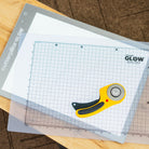 Grid cutting mat with a rotary cutter on a wooden surface