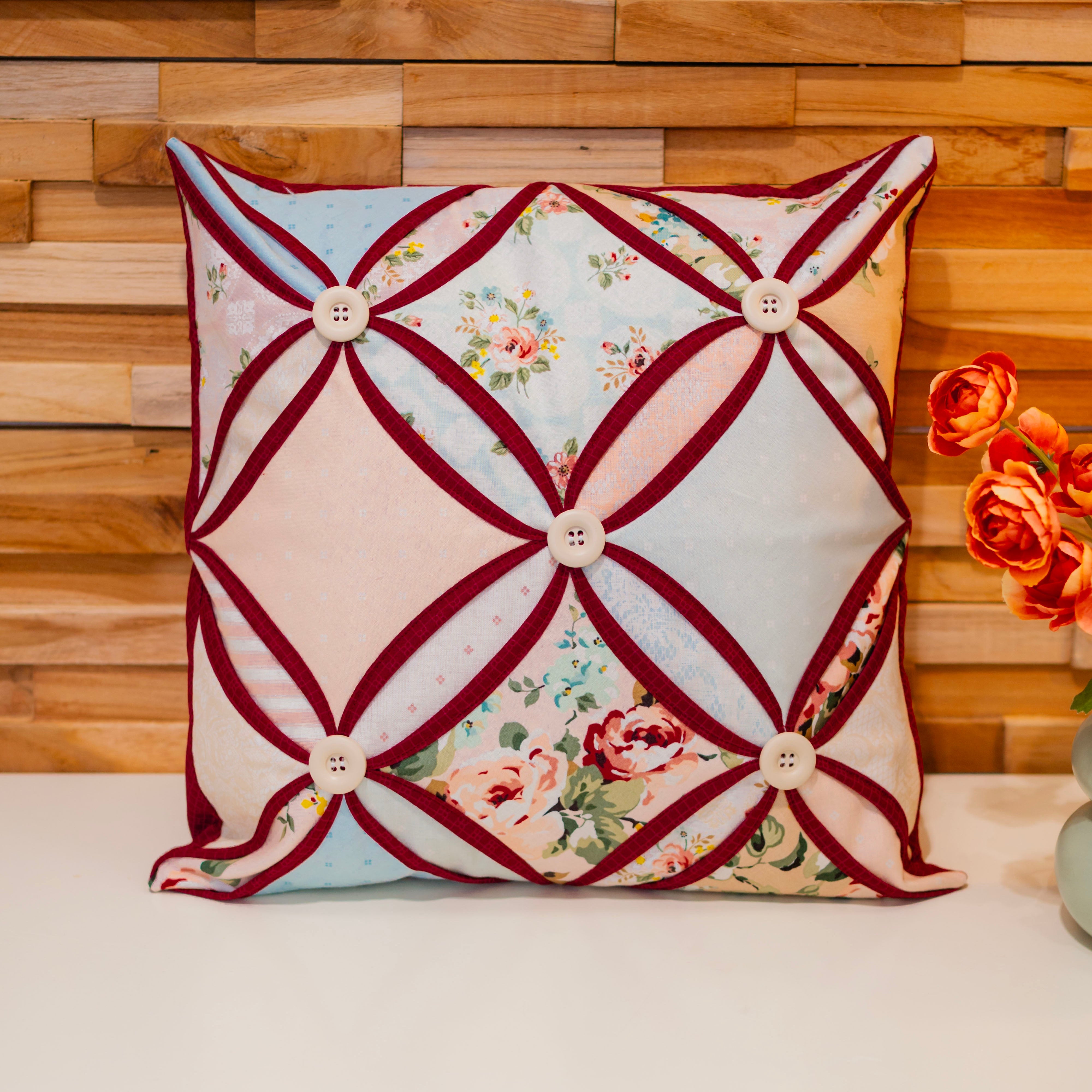 Decorative pillow with floral pattern on a wooden wall background