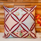 Decorative pillow with floral patterns and buttons on a wooden wall background