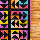 Colorful geometric quilt on a wooden surface