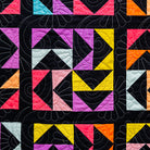 Colorful geometric quilt pattern with triangles on a black background