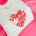 White shirt with 'Happy Valentine's Day' text on a pink background