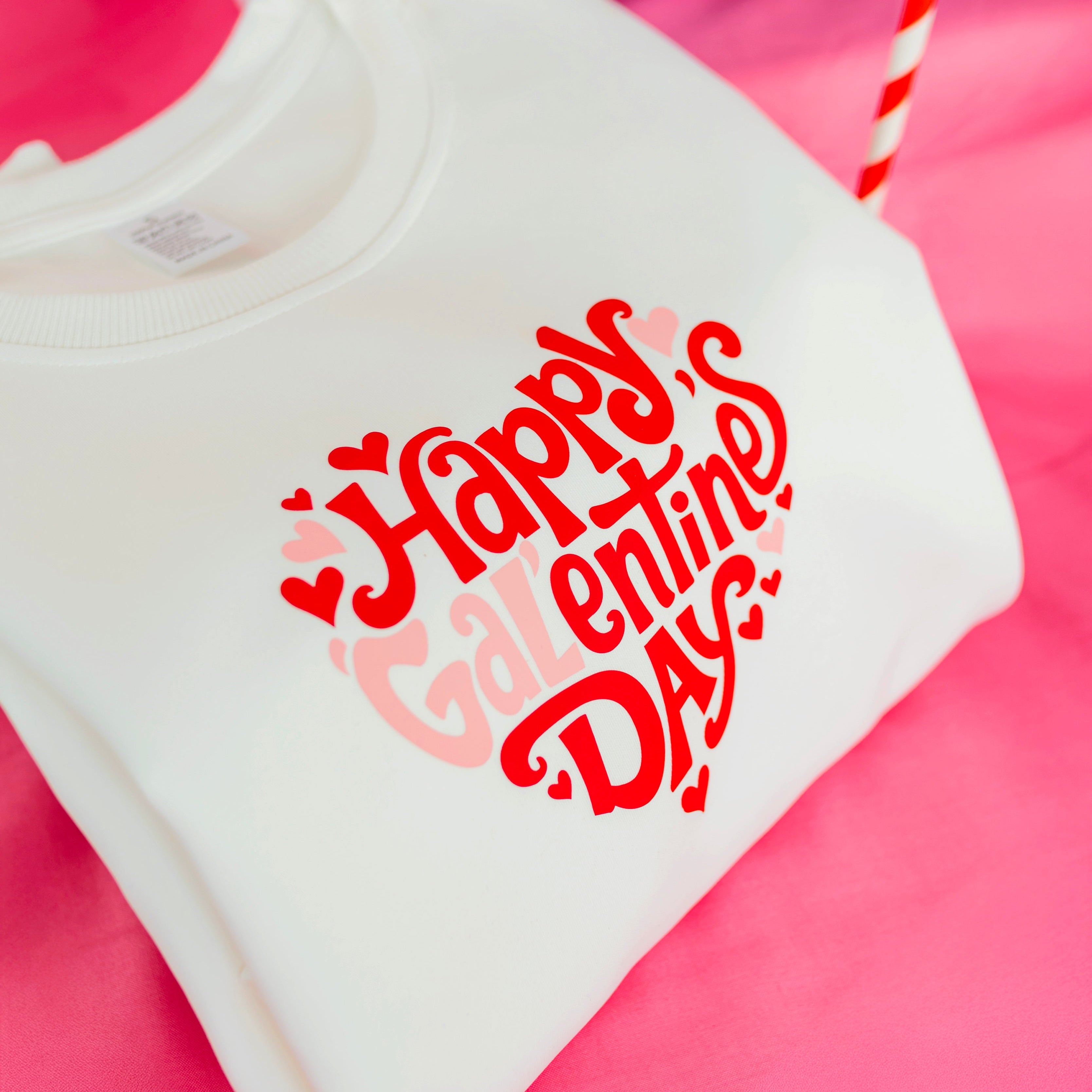 White shirt with 'Happy Valentine's Day' text on a pink background