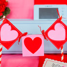 Heart-shaped decorations on sticks with a printer in the background