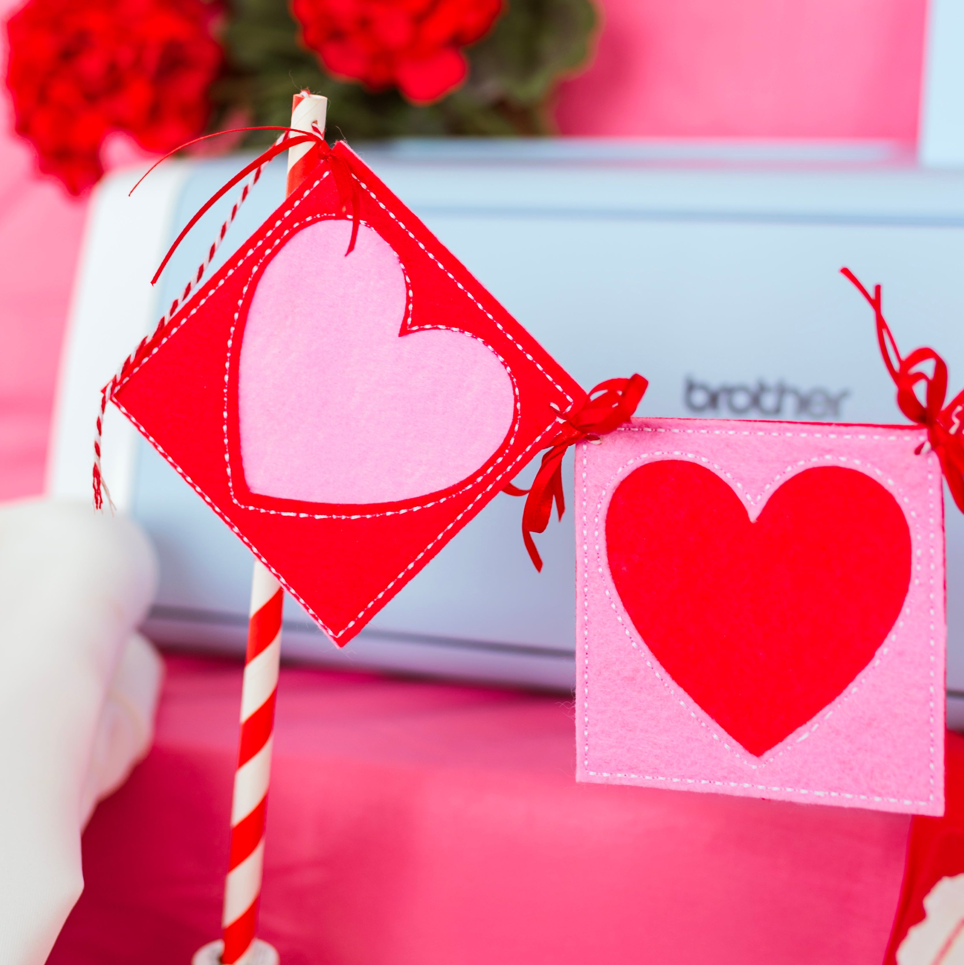 Heart-shaped flags on a spool with a pink background