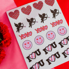 Sheet of stickers with hearts, cupids, and 'I love you' text on a red background.