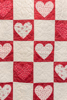 Quilt with heart patterns in red and white