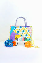 Colorful handbag with floral pattern on a white background