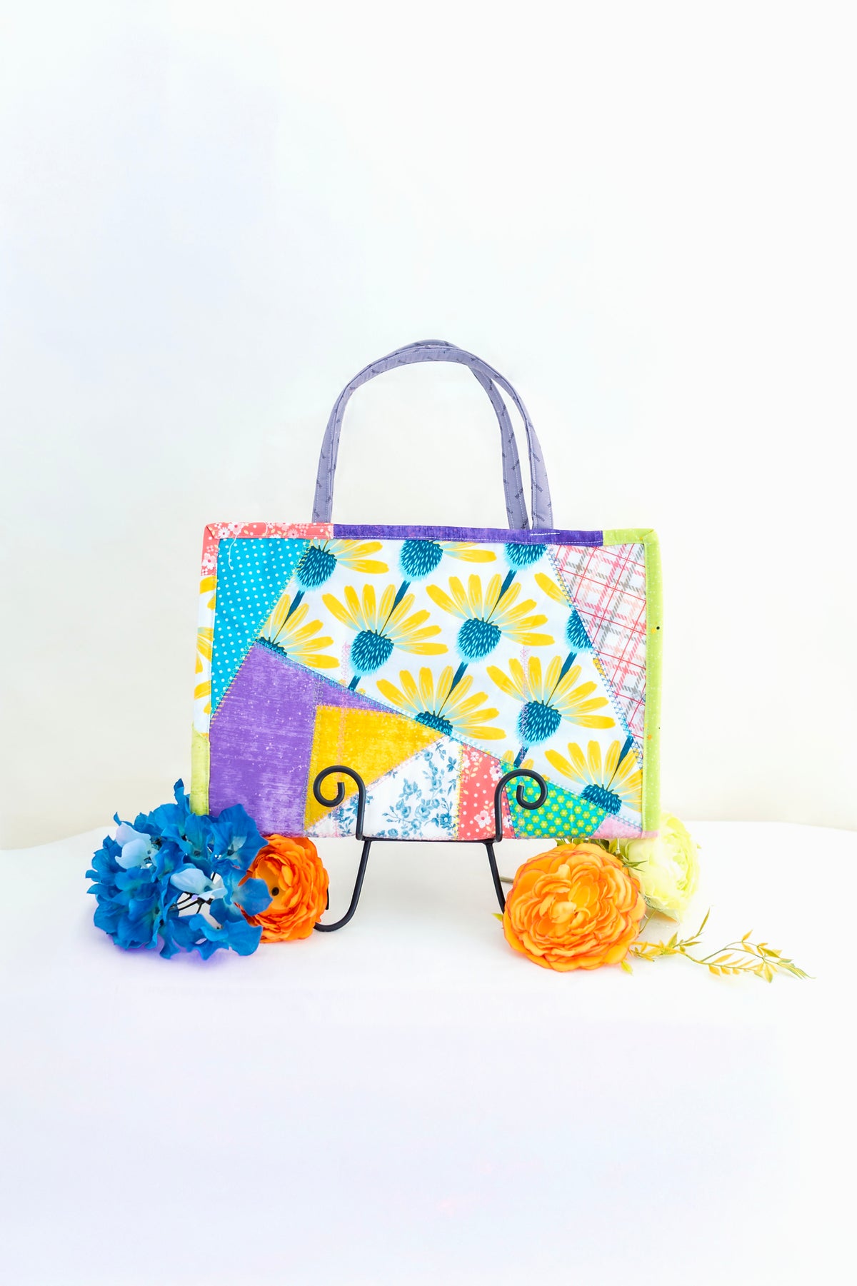 Colorful handbag with floral pattern on a white background