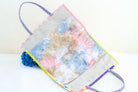 Colorful tote bag with floral design on a white background