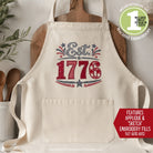 Beige apron with 'Est. 1776' design on a neutral background