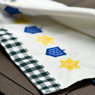 Fabric with colorful star patterns on a wooden surface