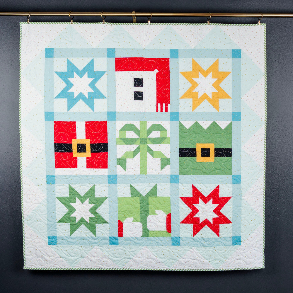 Colorful quilt with geometric patterns hanging on a dark wall