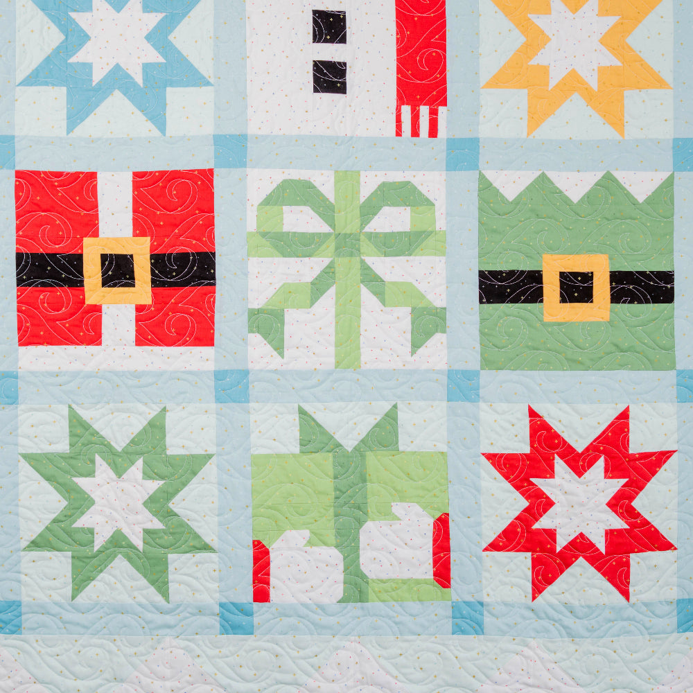 Quilt with colorful geometric patterns on a light blue background