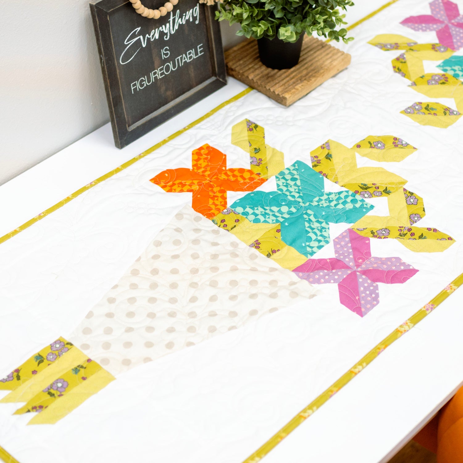 Colorful quilt with butterfly patterns on a white surface