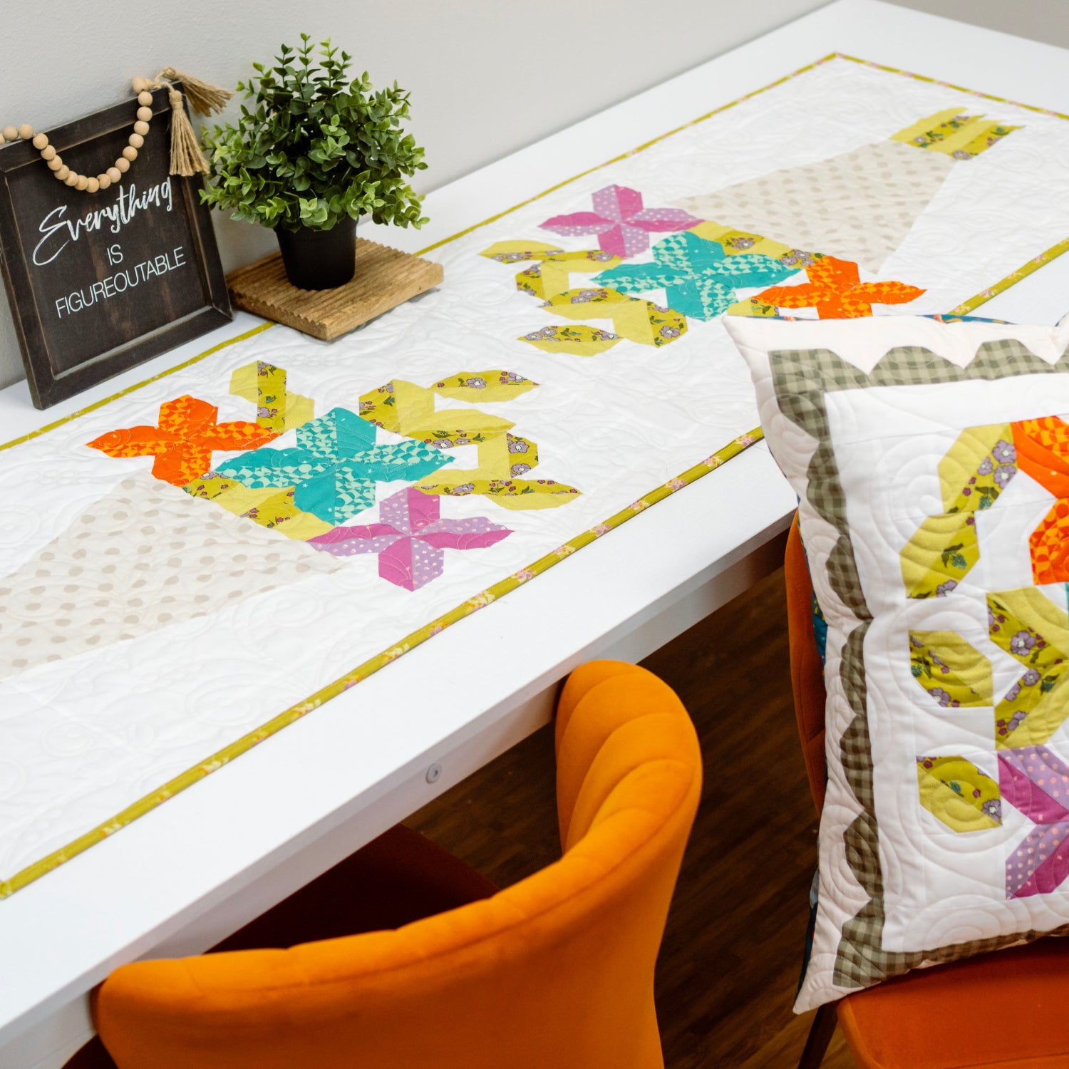 Colorful quilt with butterfly patterns on a table and chair.