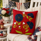 Decorative pillow with floral design on a chair with American flag decorations.