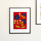 Framed artwork with blue flowers on a red background
