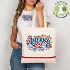 Person holding a tote bag with 'America 250' design, wearing a matching t-shirt.