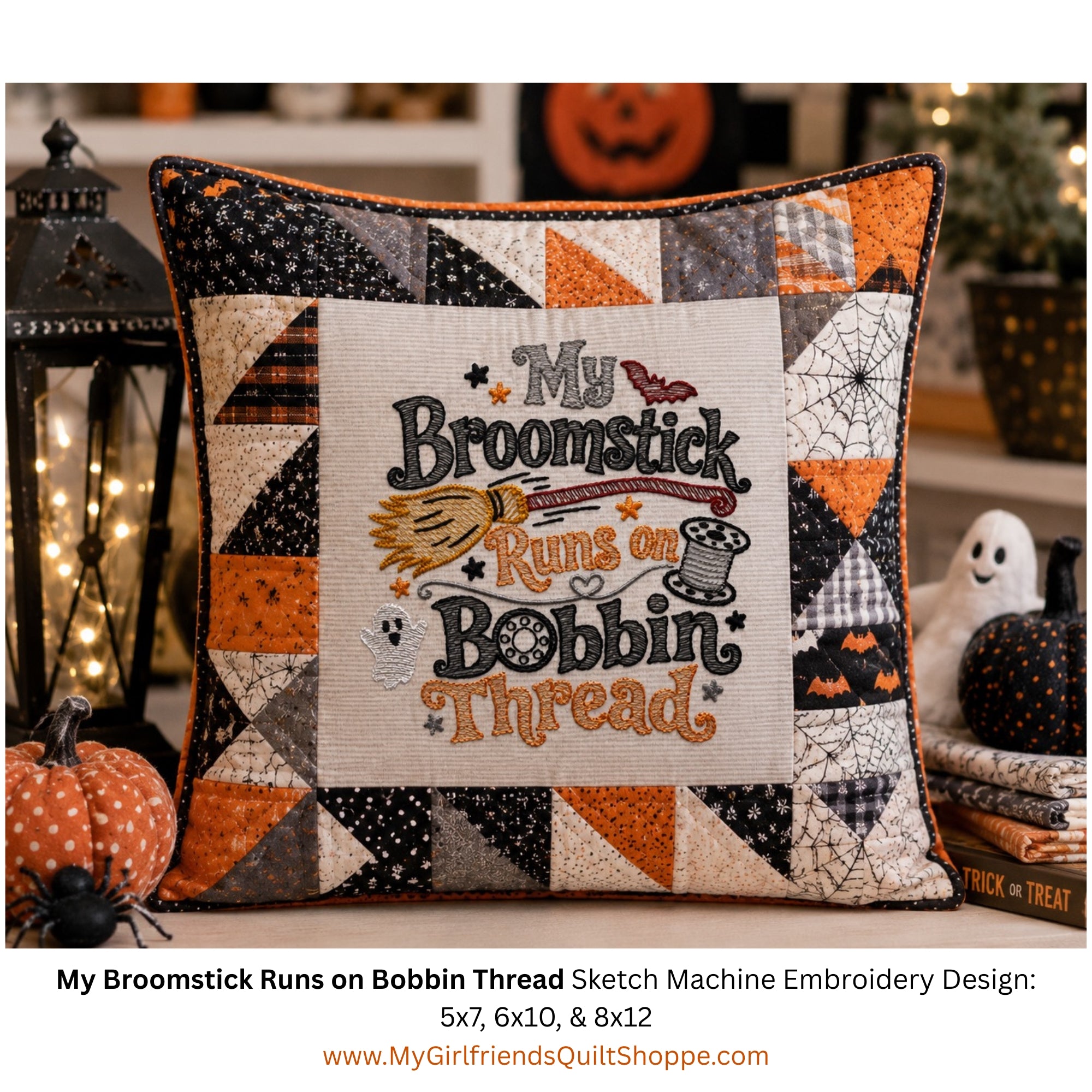 A square decorative pillow with a patchwork Halloween-themed border and a central embroidered design reading “My Broomstick Runs on Bobbin Thread,” styled on a tabletop with pumpkins, a lantern, and ghost decorations in a fall setting.