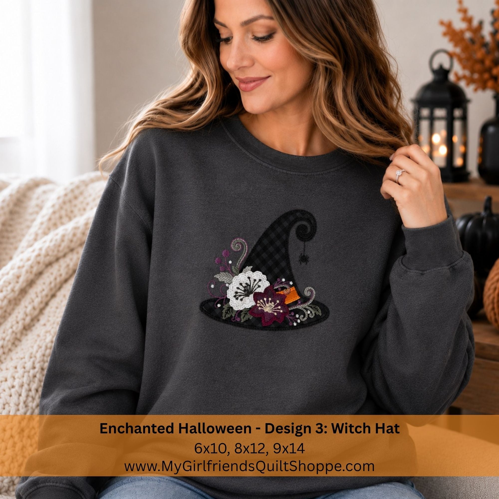 A woman wearing a dark charcoal gray sweatshirt with a witch hat graphic featuring a white cat, purple flowers, and a black plaid pattern. The image has a text banner at the bottom describing the design details and website.