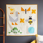 Children's animal quilt with geometric animal shapes on a dark wall