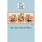 Pattern cover for the 'Hey Jack! Bench Pillow' quilted bench pillow by Jen Belnap Design, featuring three patchwork jack-o'-lanterns on a light blue background.