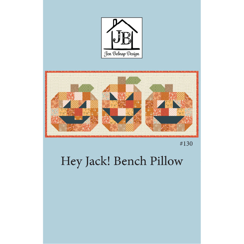 Pattern cover for the 'Hey Jack! Bench Pillow' quilted bench pillow by Jen Belnap Design, featuring three patchwork jack-o'-lanterns on a light blue background.