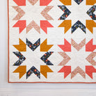 Quilt with geometric pattern on a white wall