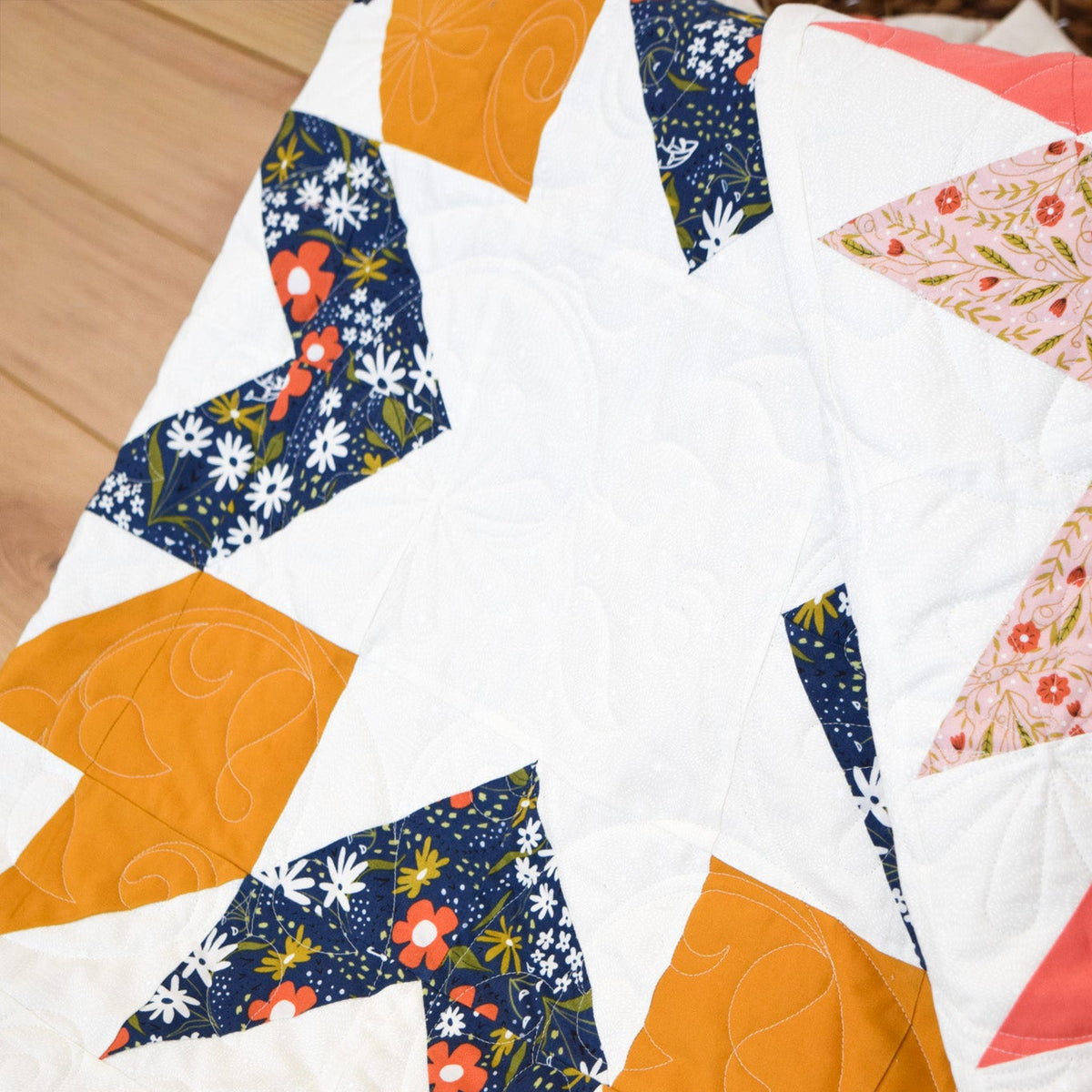 Quilt with geometric pattern on a wooden surface
