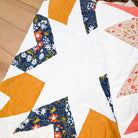 Quilt with geometric pattern on a wooden surface