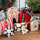 Decorative gift boxes with festive ribbons on a wooden surface with Christmas trees in the background.