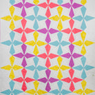 Colorful geometric quilt with star patterns on a plain background