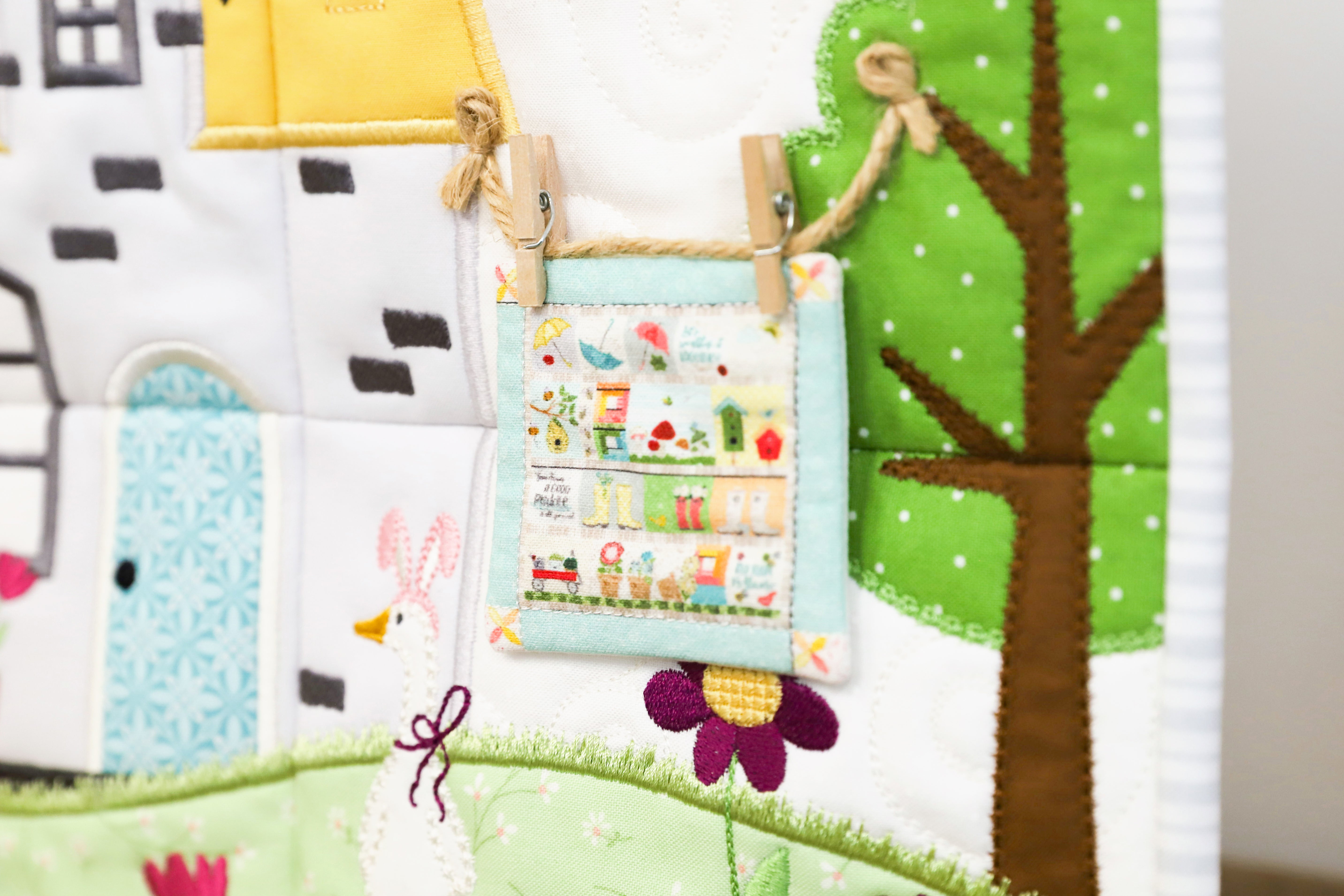 Children's play mat with fabric houses, trees, and animals