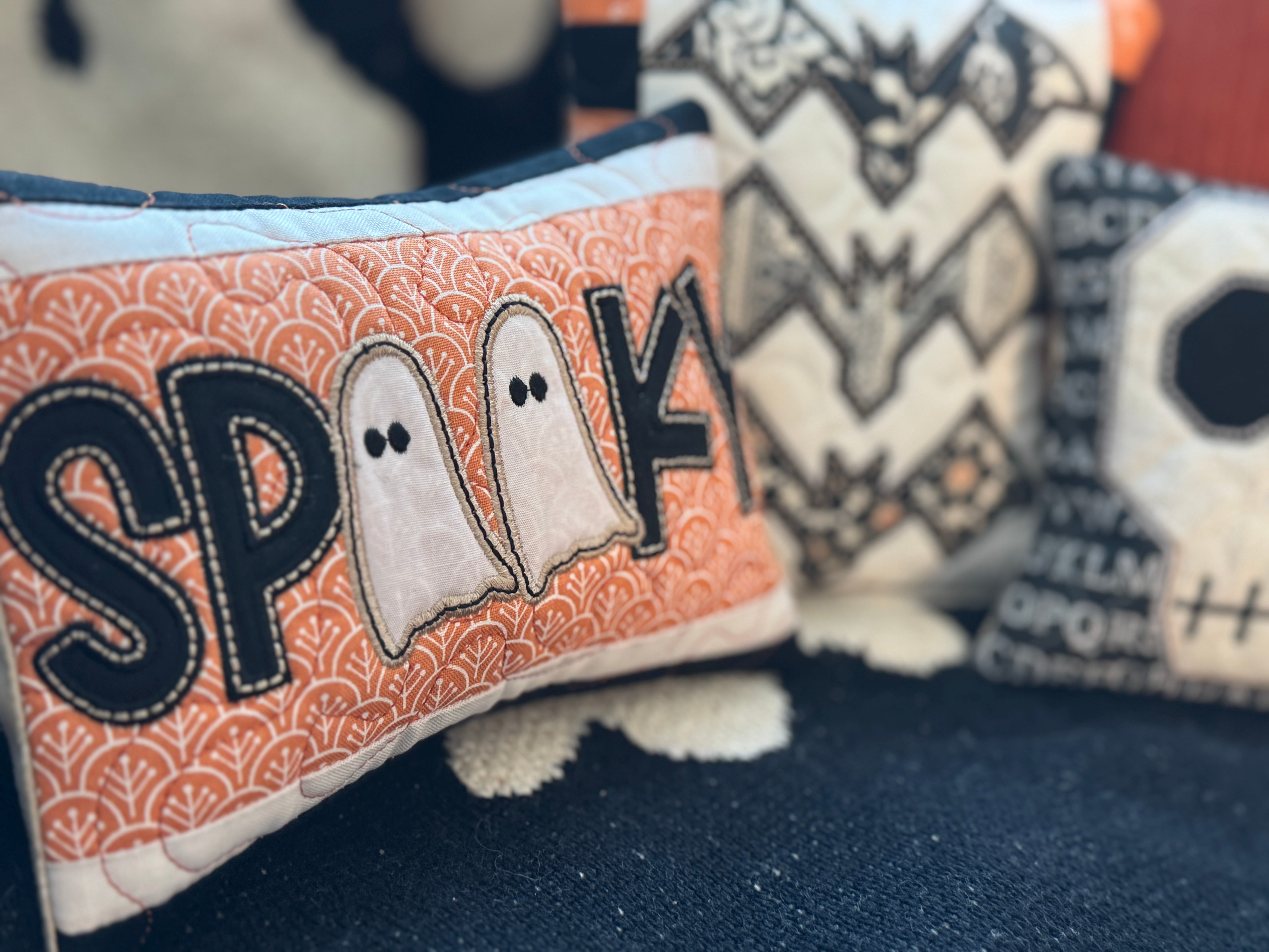 Halloween-themed plush toys with 'SPARK' and ghost designs on a dark background