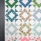 Colorful quilt with geometric pattern on a dark background