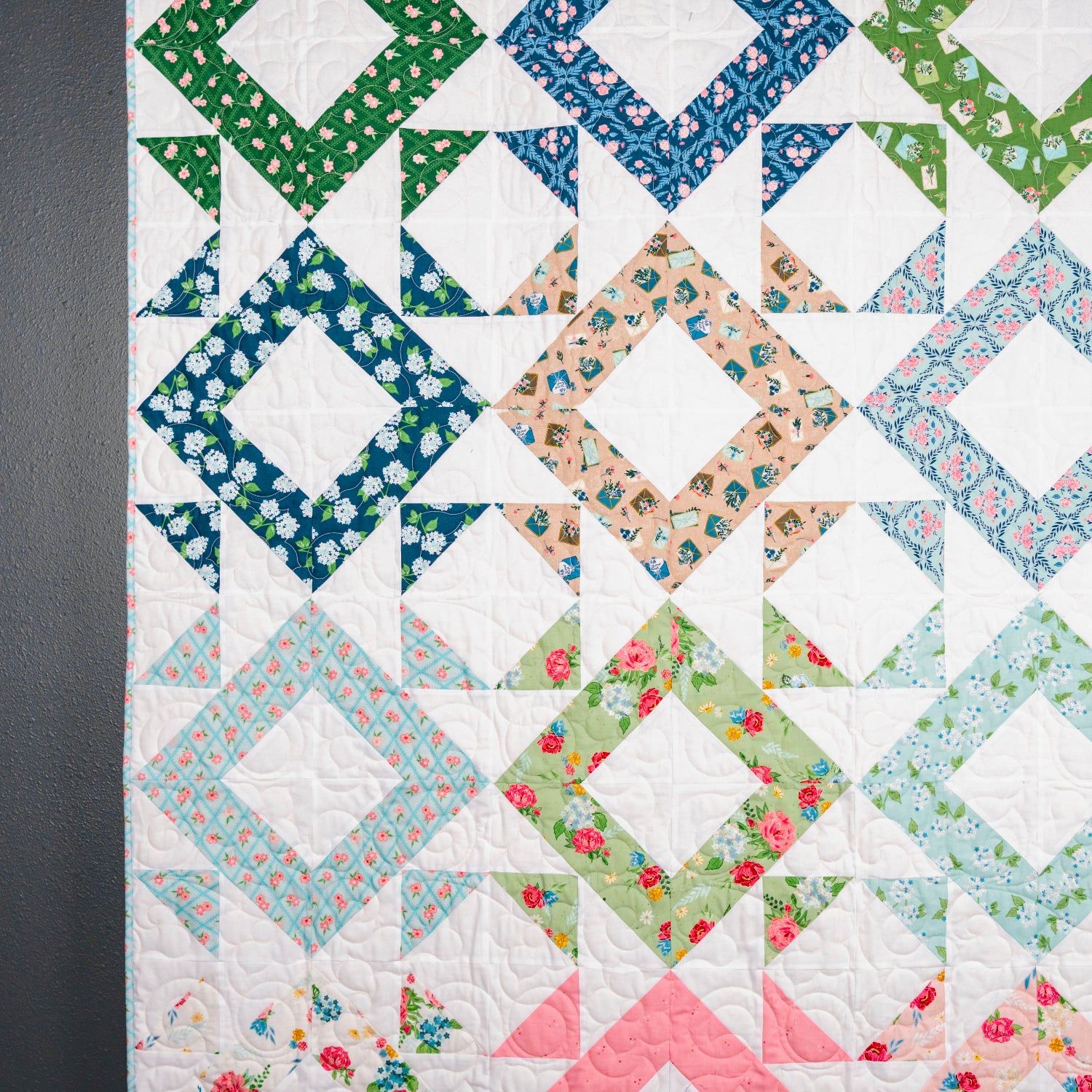 Colorful quilt with geometric pattern on a dark background