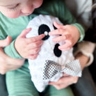 Child playing with a plush ghost toy
