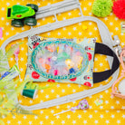 Toy car track set with colorful toys on a yellow star-patterned background