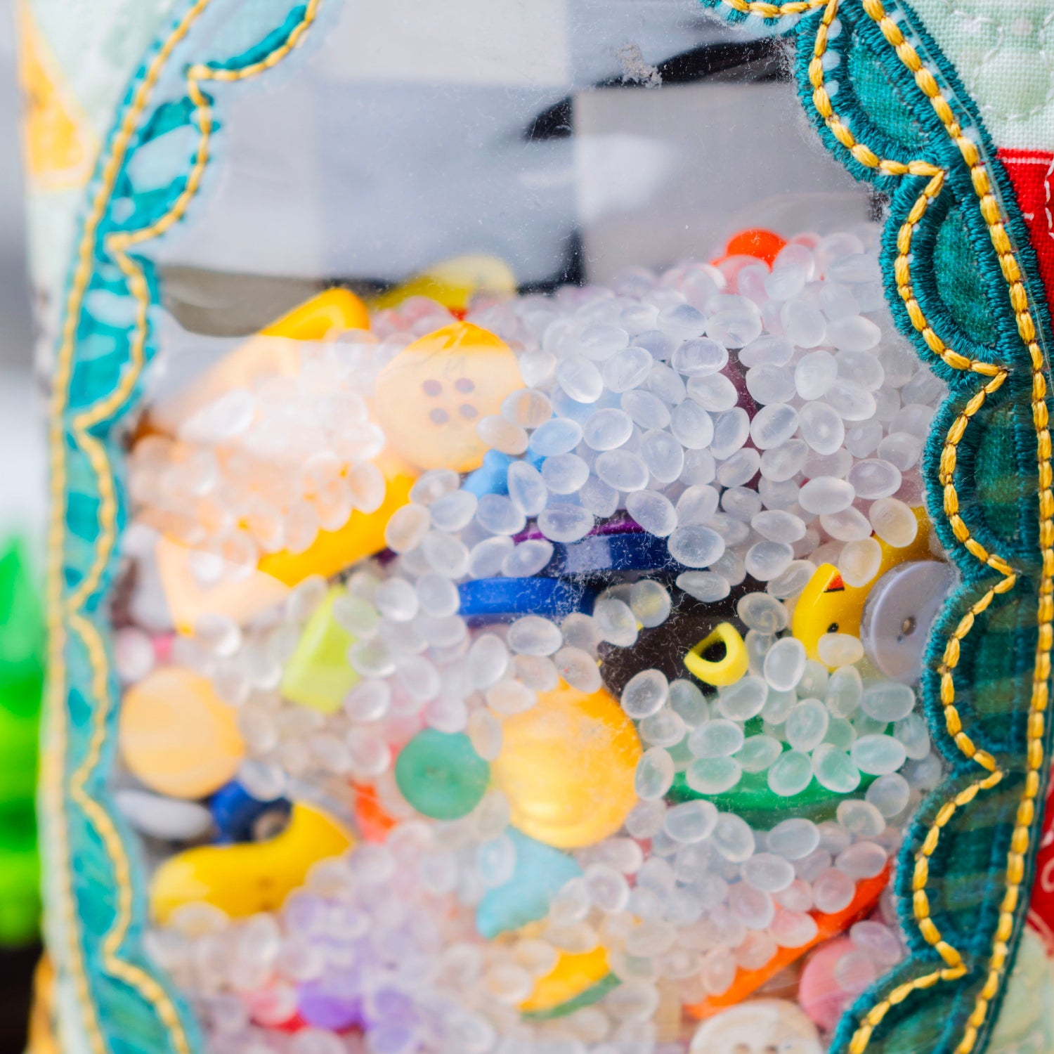 Colorful buttons and beads in a decorative frame