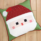 Decorative pillow with Santa Claus face design on a wooden floor